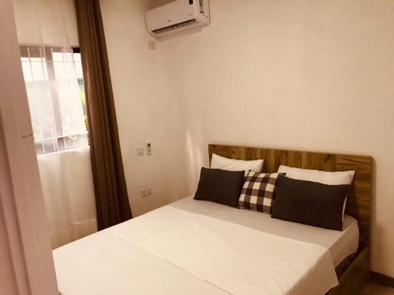 Furnished bedroom with a double bed and air conditioning